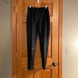 Vegan leather or Faux leather. Black pant.